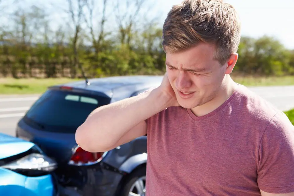 man having neck pain from auto accident
