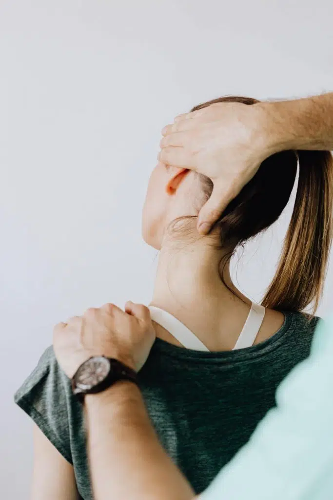 Woman receiving chiropractic treatment for Migraine Headaches